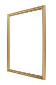 A large contemporary gilt framed rectangular wall mirror. With bevelled edge glass.