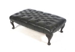 A chesterfield style green leather foot stool.