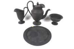 Four pieces of 19th century Wedgwood neoclassical black basalt.