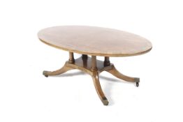 A Regency style oval cross banded coffee table.