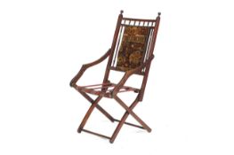 A late 19th/early 20th century mahogany folding campaign chair.