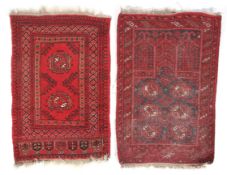 Two hand woven red woollen prayer rugs.