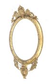 A circa 1890 gilt framed oval wall mirror.