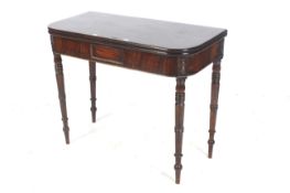 A George IV mahogany fold over tea table. Turned legs and one hinged versa, 75cm H, 92cm W, 88cm D.