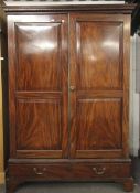 A 19th century mahogany two drawer wardrobe, H200cm x W142cm x D73cm,