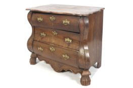 A 19th century Continental oak bombe shaped chest of drawers with three drawers.