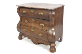 A 19th century Continental oak bombe shaped chest of drawers with three drawers.