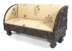 A circa 1900 carved and stained pine two-and-half seat upholstered Continental sofa.
