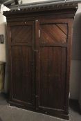 A 19th century Neo-Gothic style pine two door wardrobe.