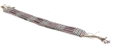 A possibly Native North American beadwork decorated belt with tassel ends.