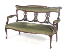 An Edwardian mahogany and green upholstered parlour sofa.