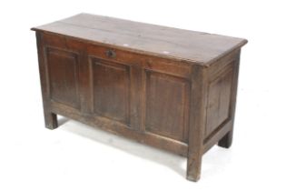 An 18th century oak three panel coffer. With panelled sides, 72 cm H x 128.5 cm W x 50.5 cm D.