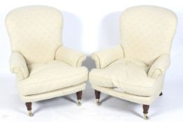A pair of contemporary cream upholstered Victorian style armchairs.