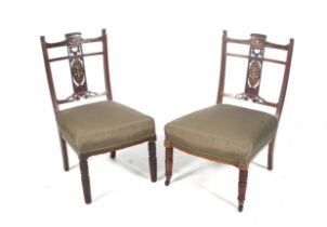 A pair of Victorian inlaid mahogany nursing chairs.