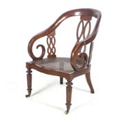 A late 19th/early 20th century cane seated open armchair.