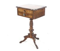 A circa 1900 walnut veneer and mahogany sewing table.