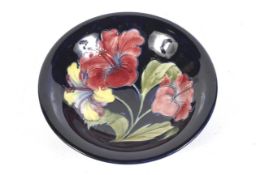 A Moorcroft Hibiscus pattern shallow bowl.