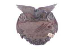 A early 20th century carved mahogany eagle crest wall plaque.