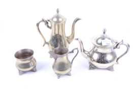A Middle Eastern silver plated and brass four piece tea and coffee service.