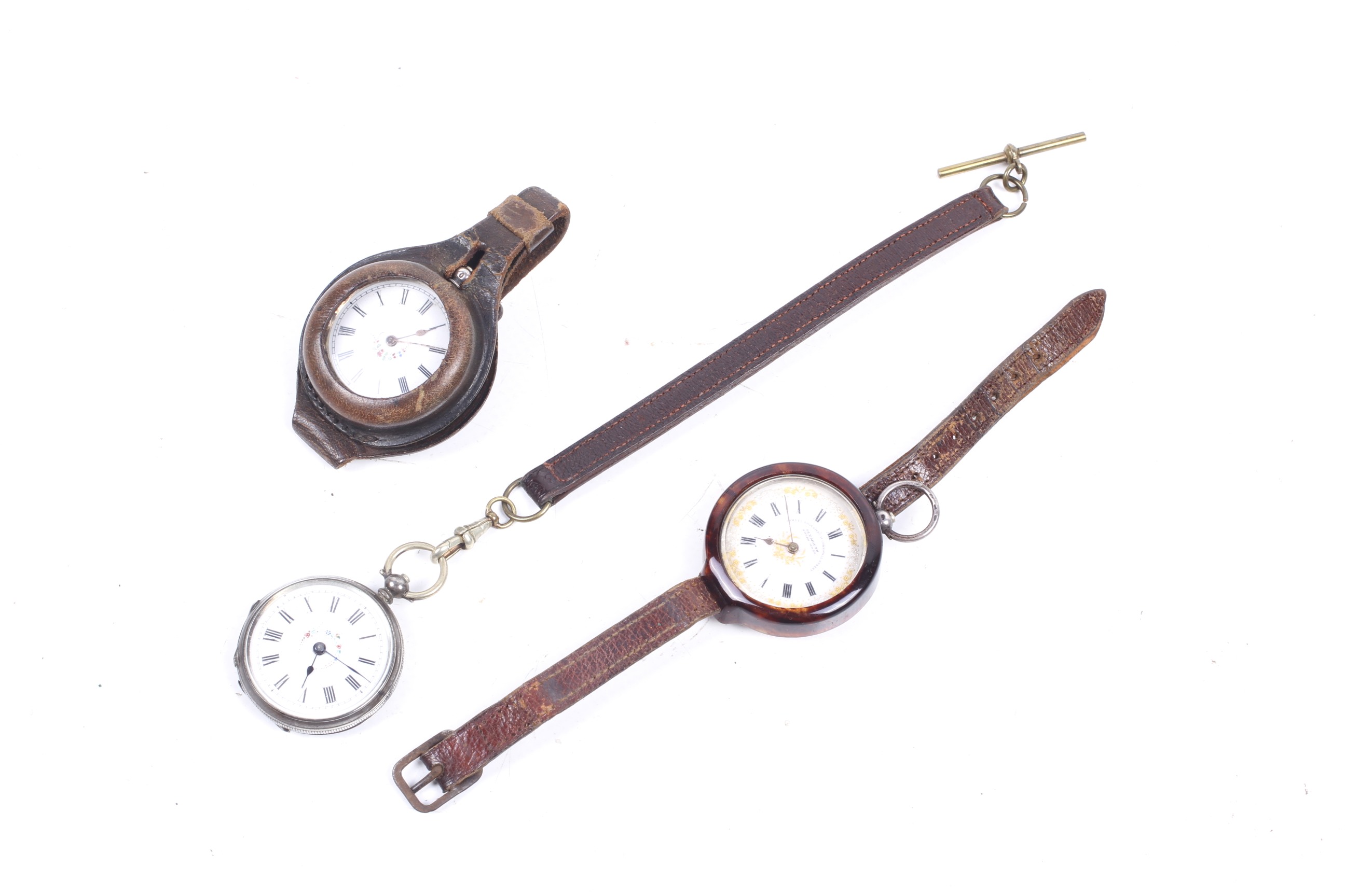 Three silver pocket watches with WWI leather wrist straps.