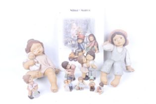 A collection of Goebel Hummel figures and a booklet.