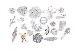 Twenty various brooches, mostly set with white crystal or paste.