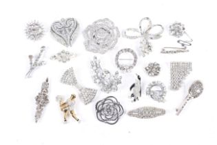 Twenty various brooches, mostly set with white crystal or paste.