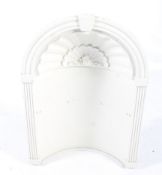 An architectural plaster alcove. With an arched top, fluted columns and shell moulding.