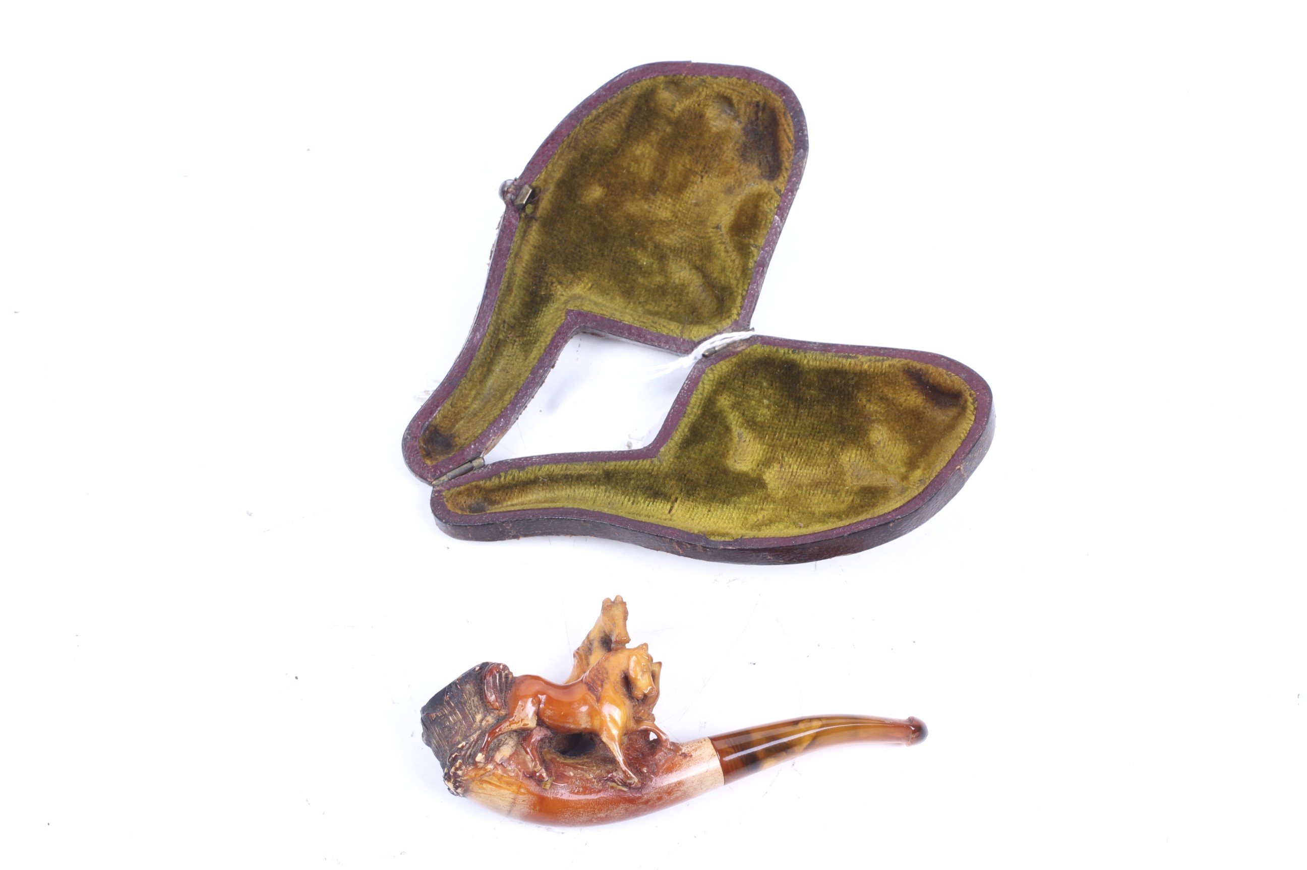 A late Victorian meerschaum pipe. Carved with two horses, in a fitted green velvet lined case, L9.