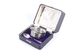 A George V silver two-handled christening bowl and spoon, in a case.