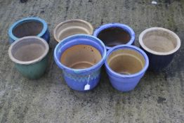 A group of seven small blue and green glazed garden plant pots. Max.