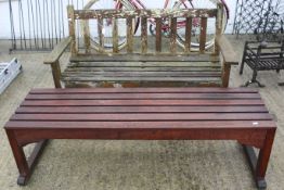 A traditional wooden garden bench and a slatted wooden bench.