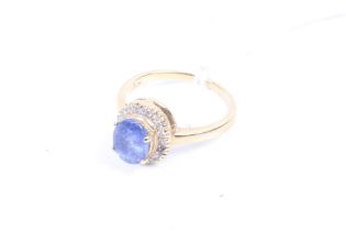 A vintage gold sapphire and diamond oval cluster ring. Stamped '750', size K, 3.