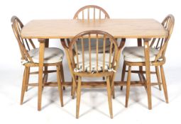 A mid-century rectangular dining table and four chairs.