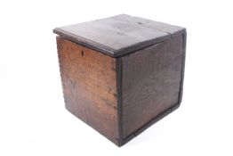 An early 18th century oak box. With a hinged lid and lock, H34cm x W33cm x D34.
