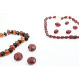 Five faceted 'red' amber beads and an imitation-amber necklace.