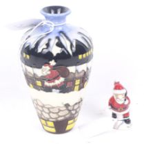 A Moorcroft Pottery Christmas in the Pots vase and a Santa Claus figure.