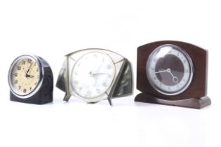 Three vintage mechanical clocks.