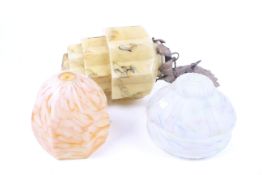 A collection of three assorted mid-century glass ceiling lamp shades.