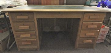 An early 20th century solid oak twin pedestal desk.