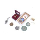 An assortment of silver, coins and costume jewellery.