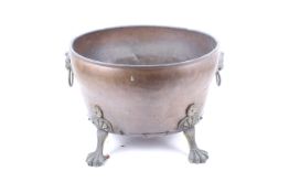 A Victorian copper coal bucket. With brass lion head handles and claw feet, H30.