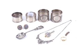 A collection of jewellery and various silver napkin rings.