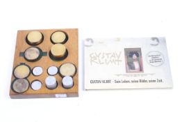A set of twelve Gustav Klimt German stamps and a set of twelve weights.