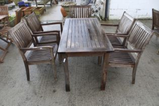 A set of wooden garden furniture. Including a rectangular garden table and five matching chairs.