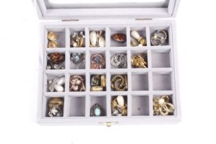 A grey earring display box containing approximately 24 pairs of costume earrings.