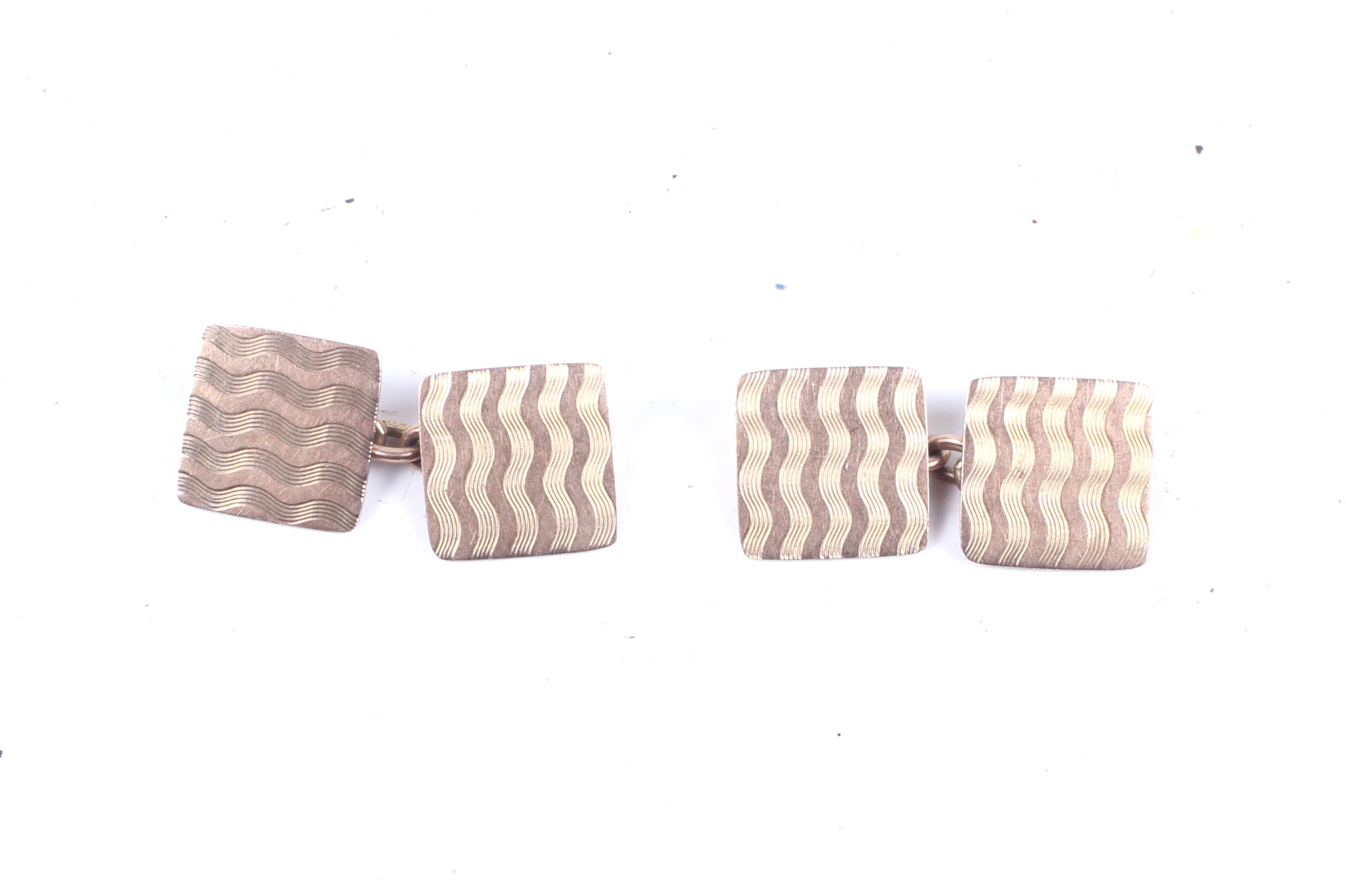 A pair of 9ct gold square engine-turned cufflinks With chain interlinks,