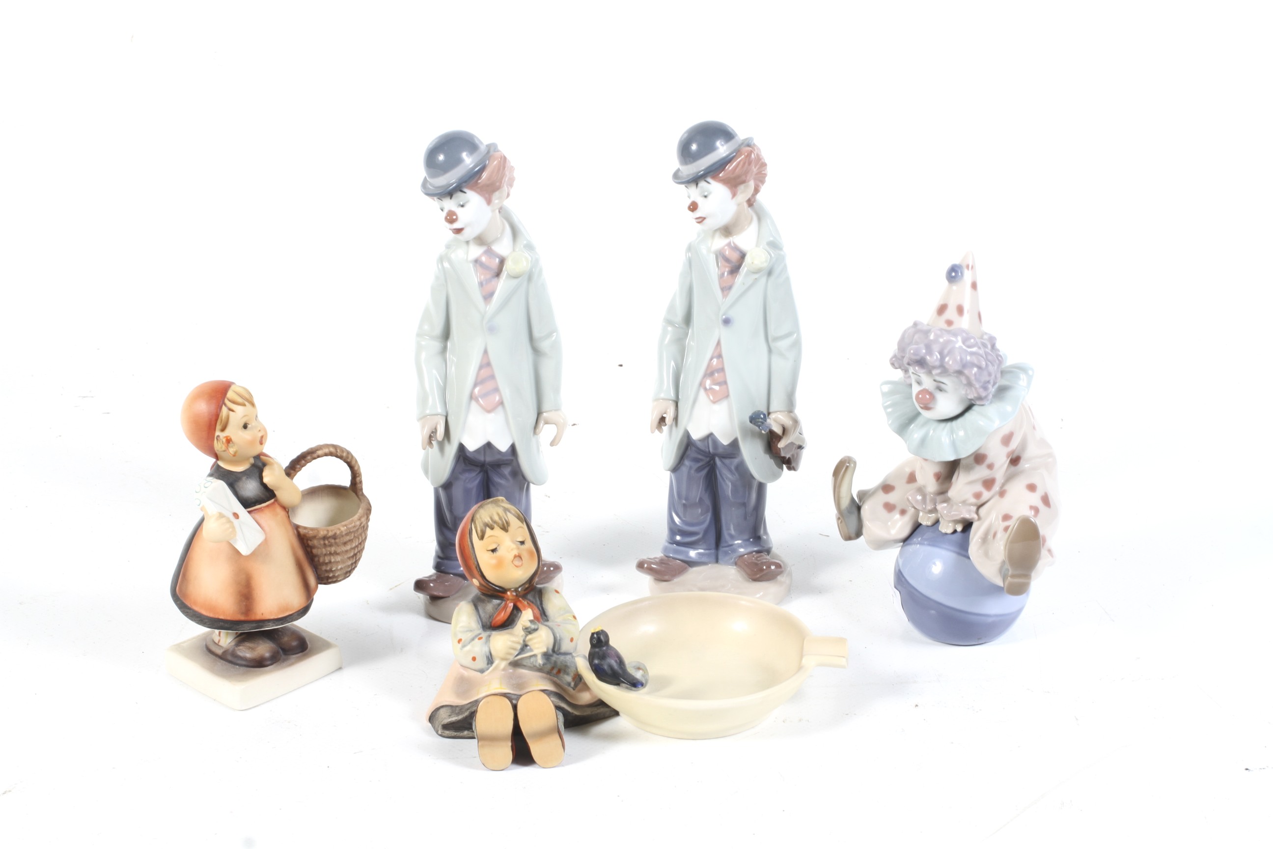 Two West German Goebel Hummel figures and three Lladro clowns.