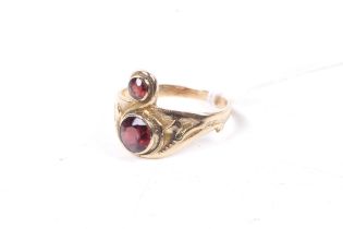 A gold and garnet two stone 'Claddagh' type ring.