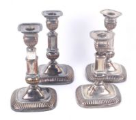 Two pairs of 19th century silver plated-copper oblong candlesticks.